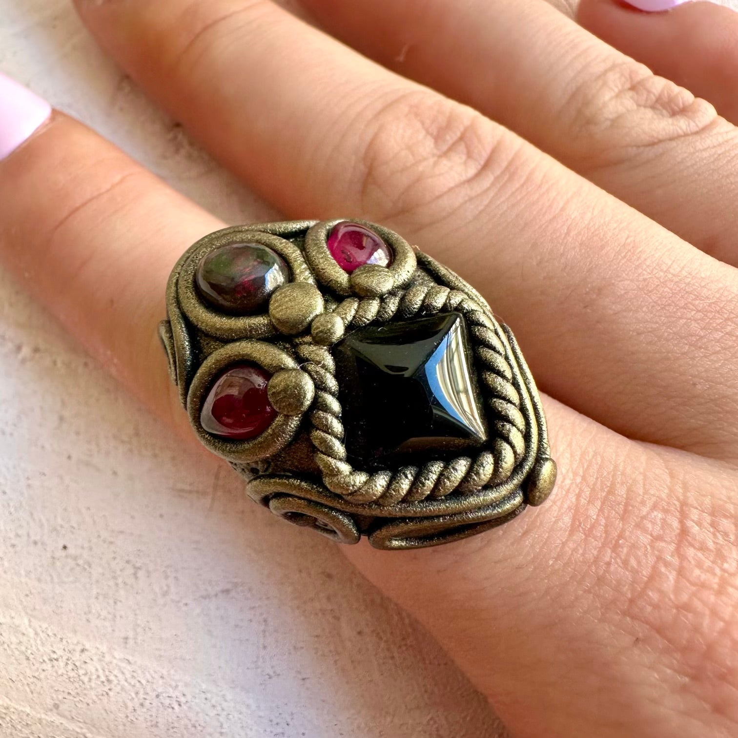 Handmade healing crystal ring featuring Black Onyx, Black Ethiopian Opal and Rhodolite Garnet.