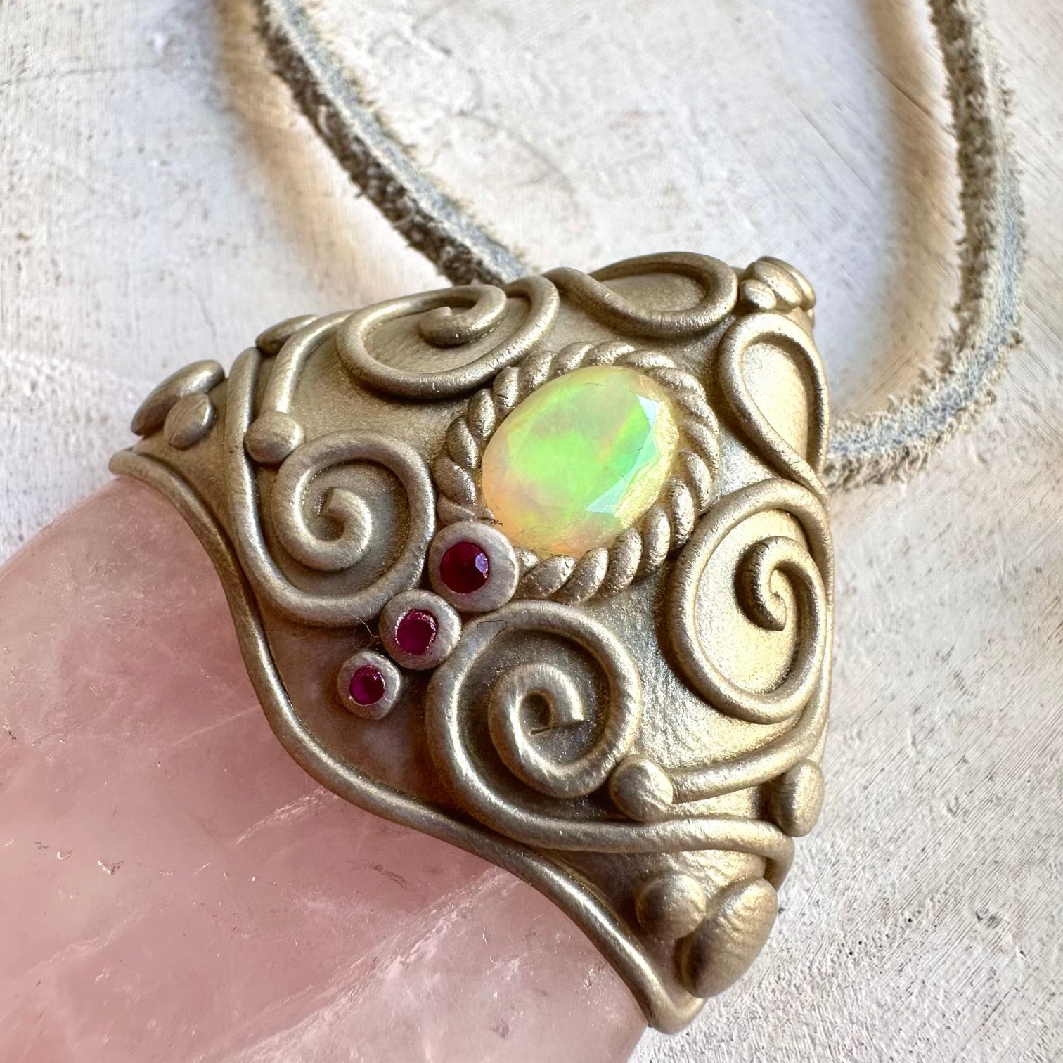 Unique gemstone pendant featuring Rose Quartz with iridescent Ethiopian Opal and rich red Ruby.