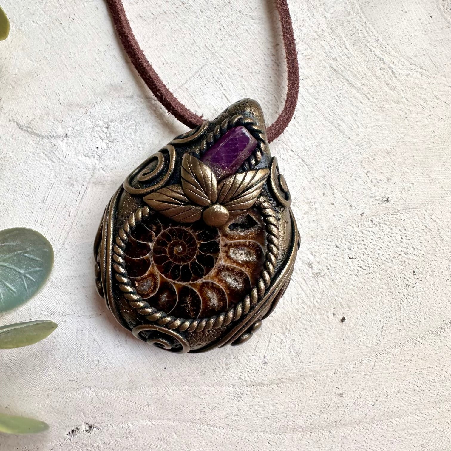 Fantasy-inspired healing gemstone necklace with natural Ruby crystal and ancient Ammonite fossil.