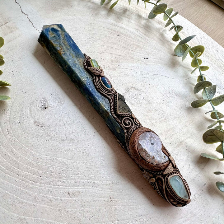 Raw Moldavite adds a vivid green accent to this handmade Blue Kyanite wand with Aquamarine, Peridot and Black Ethiopian Opal.