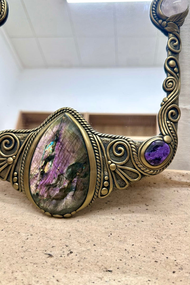 Handmade healing crystal home decor featuring a large mirror with Amethyst, Clear Quartz, Charoite and Labradorite.