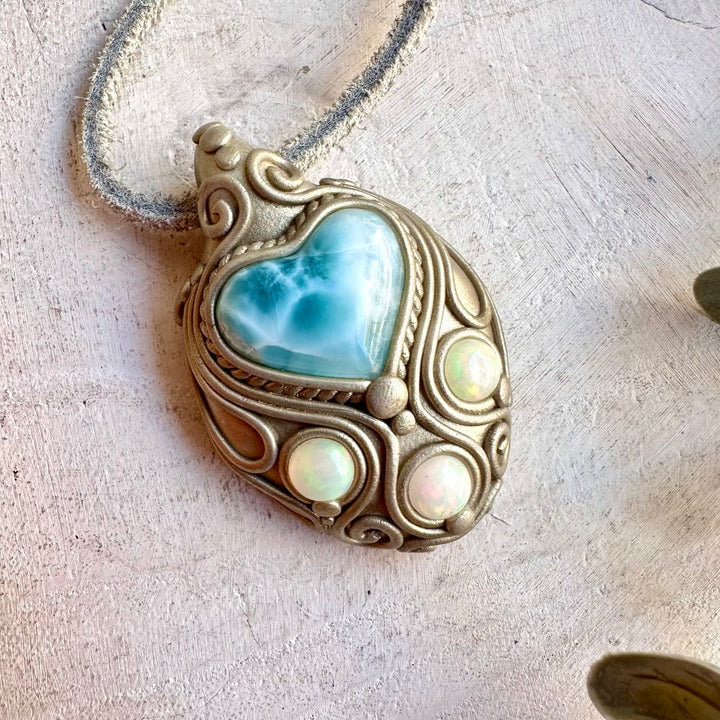 Healing crystal jewelry showcasing a Larimar Heart with colorful Ethiopian Opal.