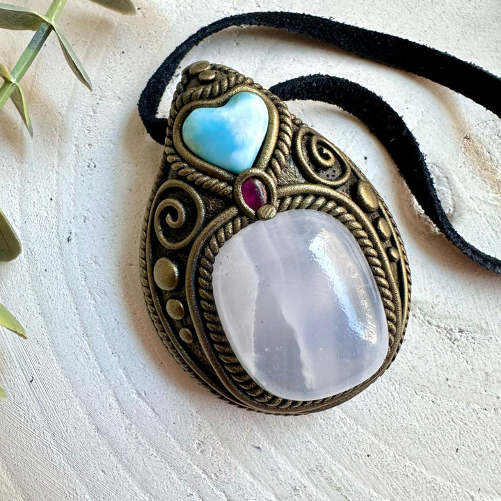Artisan crystal jewelry showcasing Mango Calcite with a natural Larimar Heart.