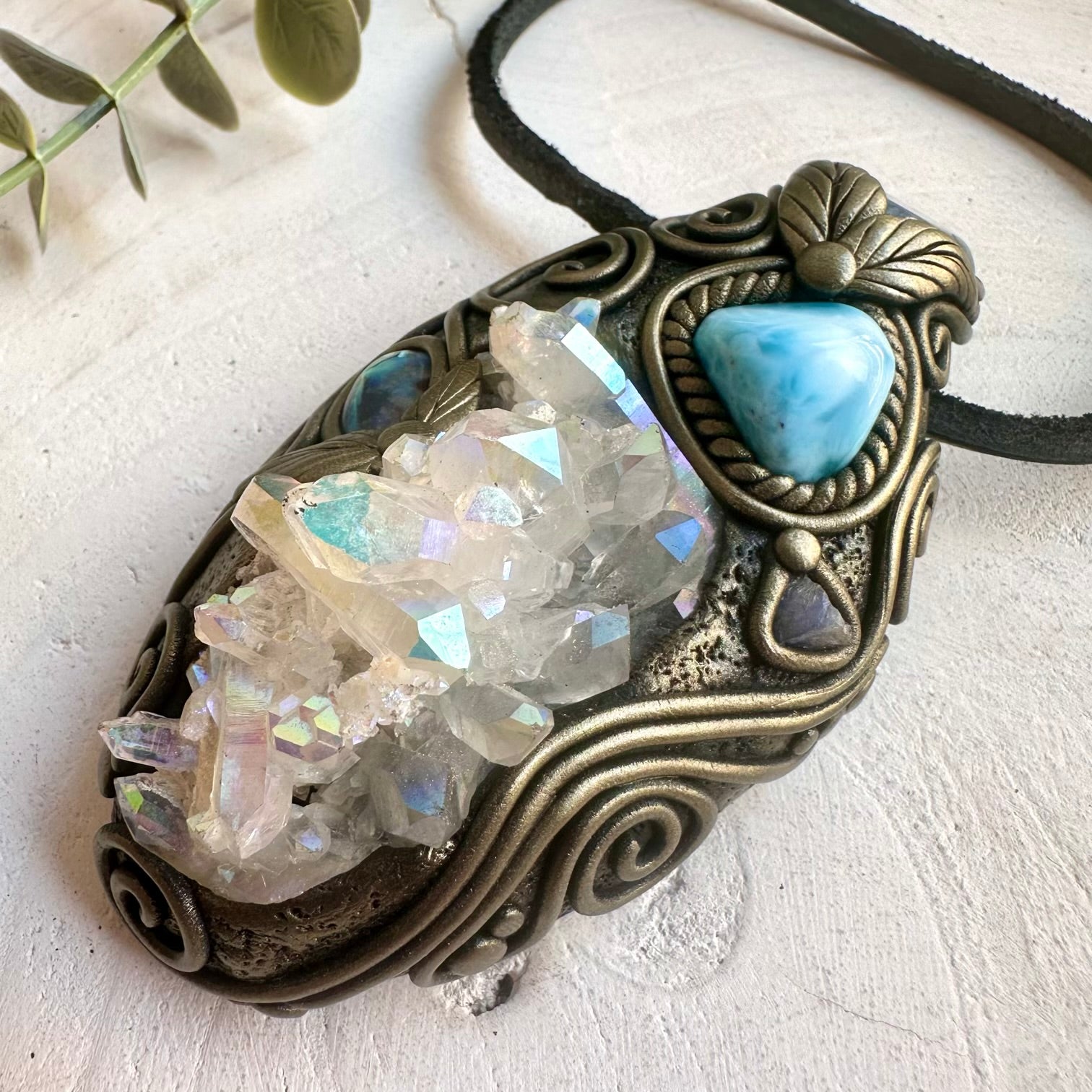 Metaphysical crystal jewelry featuring Angel Aura Quartz, Larimar, Aqua Aura Quartz and Abalone Seashell.