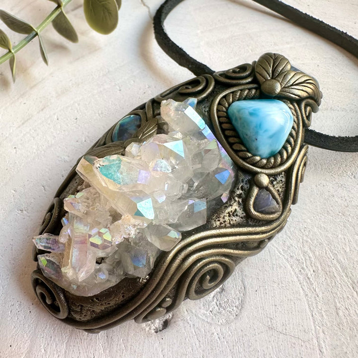 Metaphysical crystal jewelry featuring Angel Aura Quartz, Larimar, Aqua Aura Quartz and Abalone Seashell.
