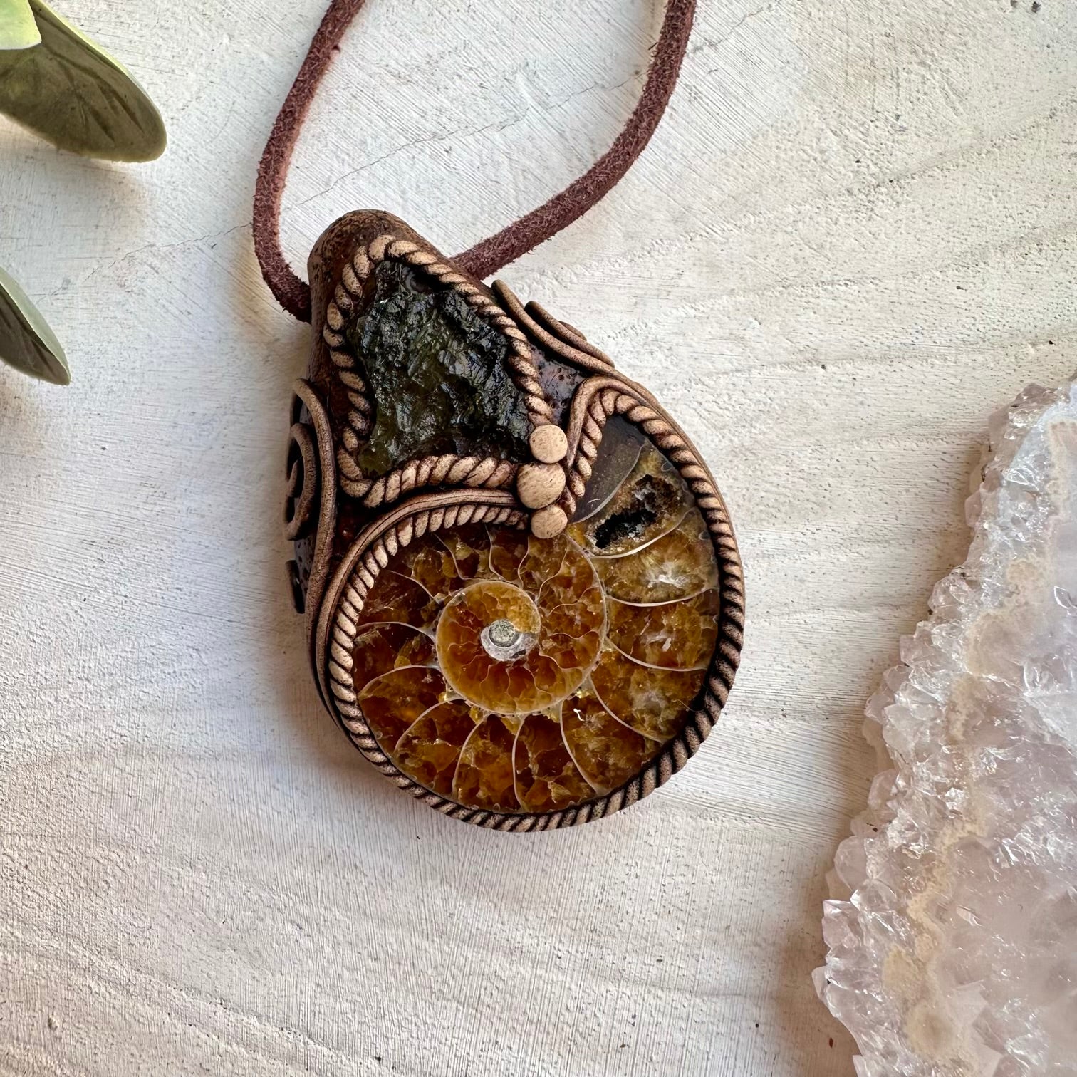 Handmade necklace featuring moldavite and ammonite fossil