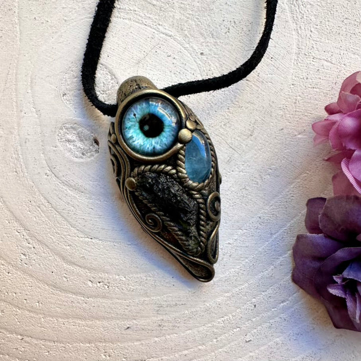 Ethically sourced raw green Moldavite paired with blue Aquamarine eye amulet, handcrafted spiritual necklace.