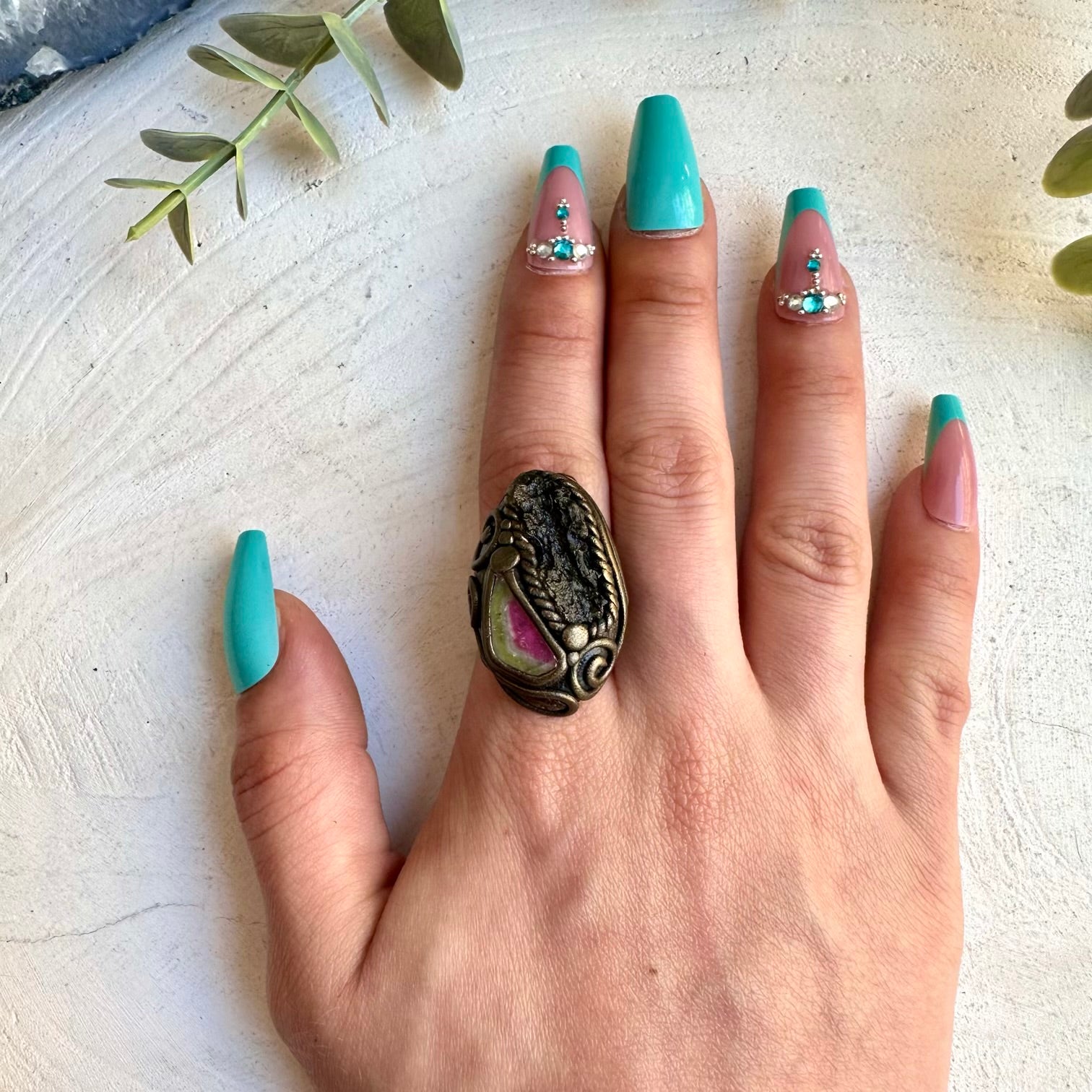 Watermelon tourmaline paired with moldavite in a ring