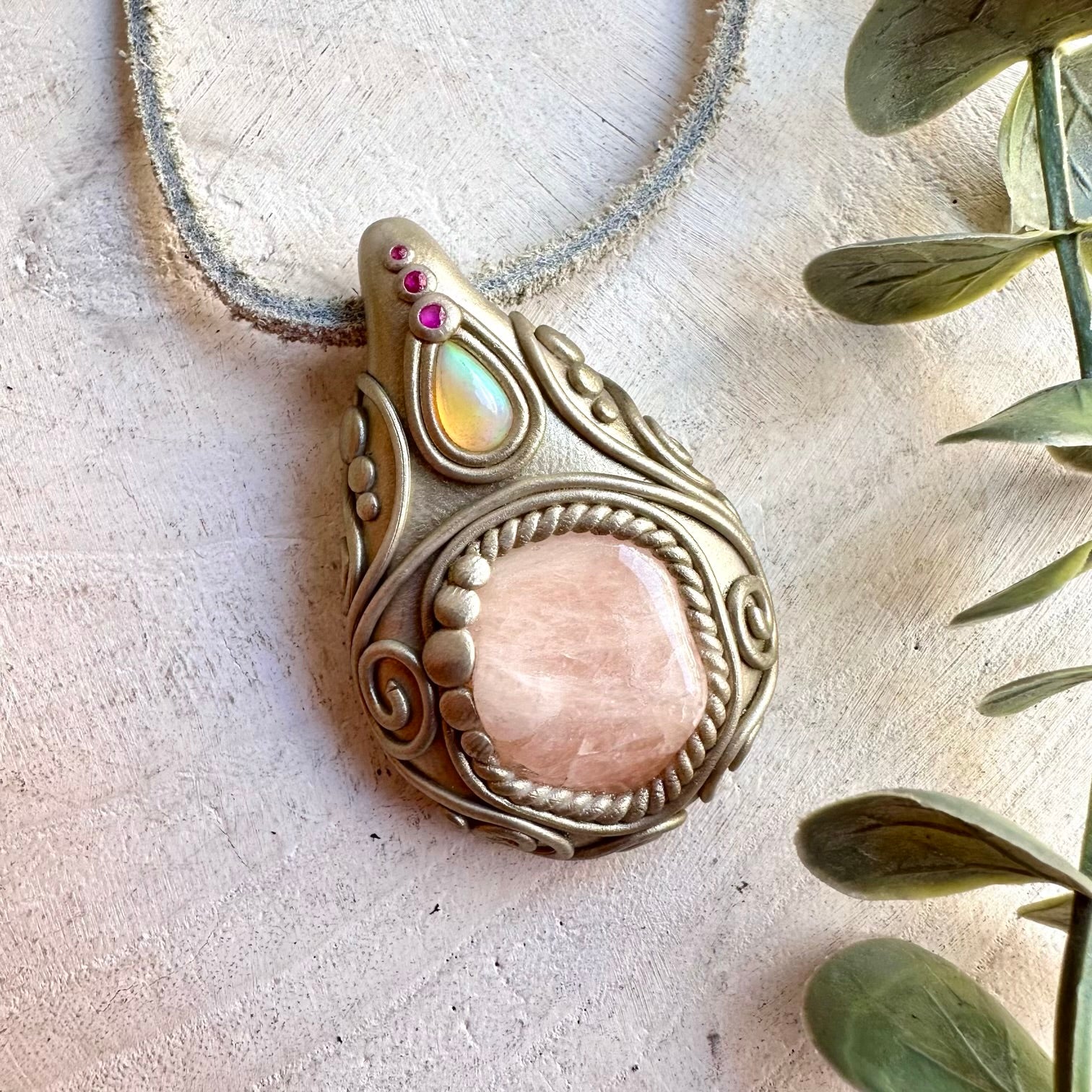 Handmade healing crystal jewelry showcasing Morganite, iridescent Ethiopian Opal and rich red Ruby.