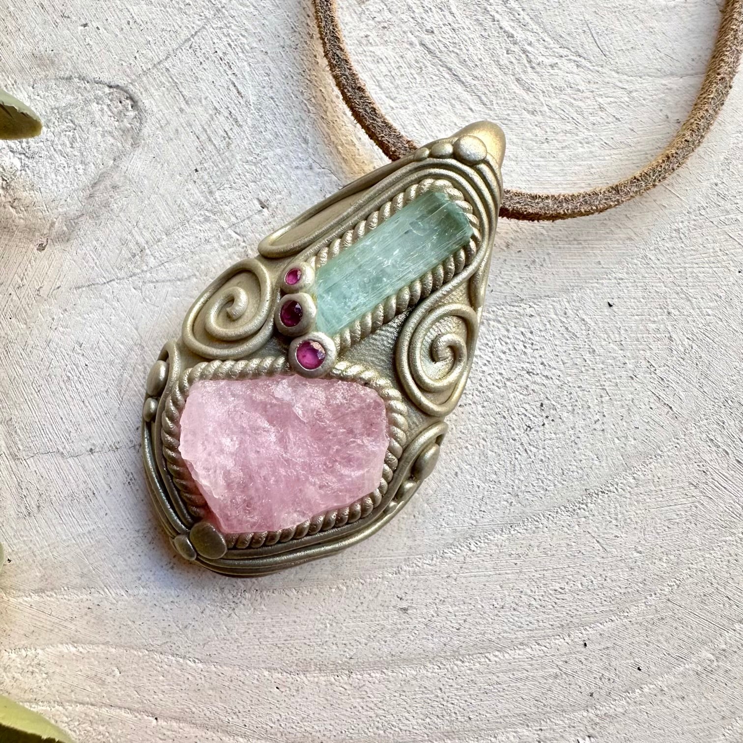 Morganite paired with aquamarine and ruby in a necklace