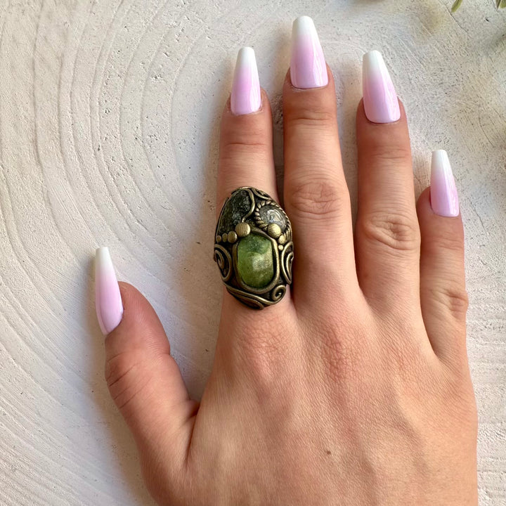 Handmade adjustable ring featuring natural Moldavite, Peridot and Clear Topaz gemstones.