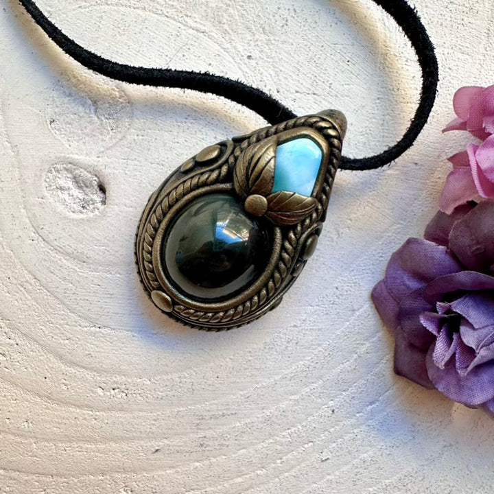 Ethically sourced Rainbow Obsidian crystal with ocean-blue Larimar pendant, handcrafted healing metaphysical necklace.