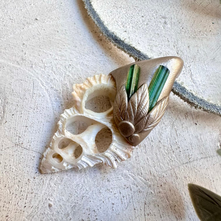 Healing crystal jewelry featuring seashell slice and green gemstone