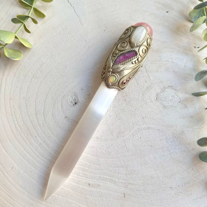 Handmade Selenite Crystal Wand adorned with Rose Quartz, Moonstone, Watermelon Tourmaline, Ethiopian Opal and Ruby, a one of a kind healing crystal tool created for meditation, energy work, intention setting and spiritual rituals.