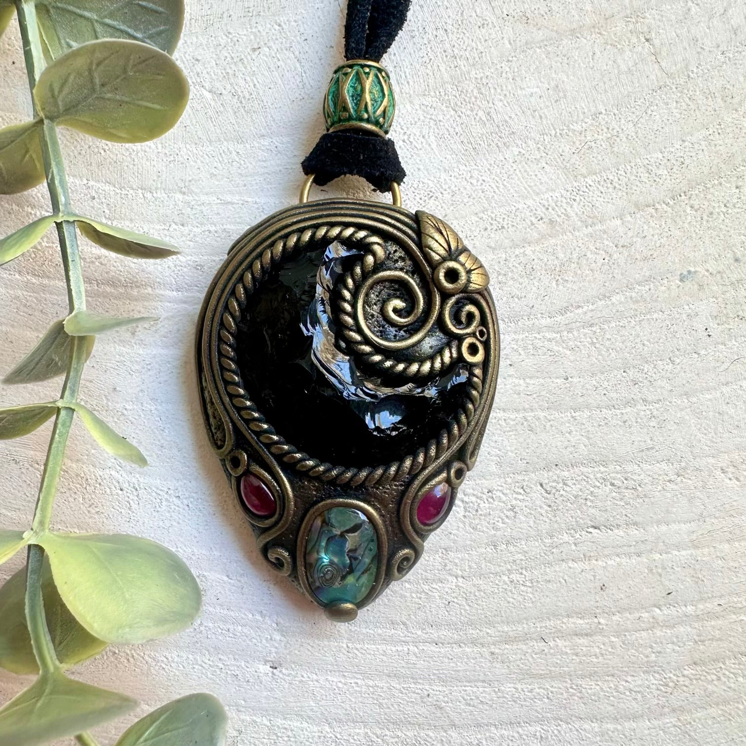 Natural gemstone jewelry showcasing a Black Obsidian Moon with colorful Abalone Seashell accents.