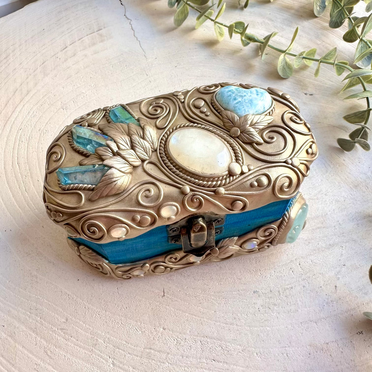Handmade crystal-decorated box featuring Aqua Aura Quartz, Aquamarine, a Larimar Heart, Rainbow Moonstone and Ethiopian Opal, a one of a kind piece of spiritual home decor created for crystal lovers, sacred spaces, altars and mystical interiors.