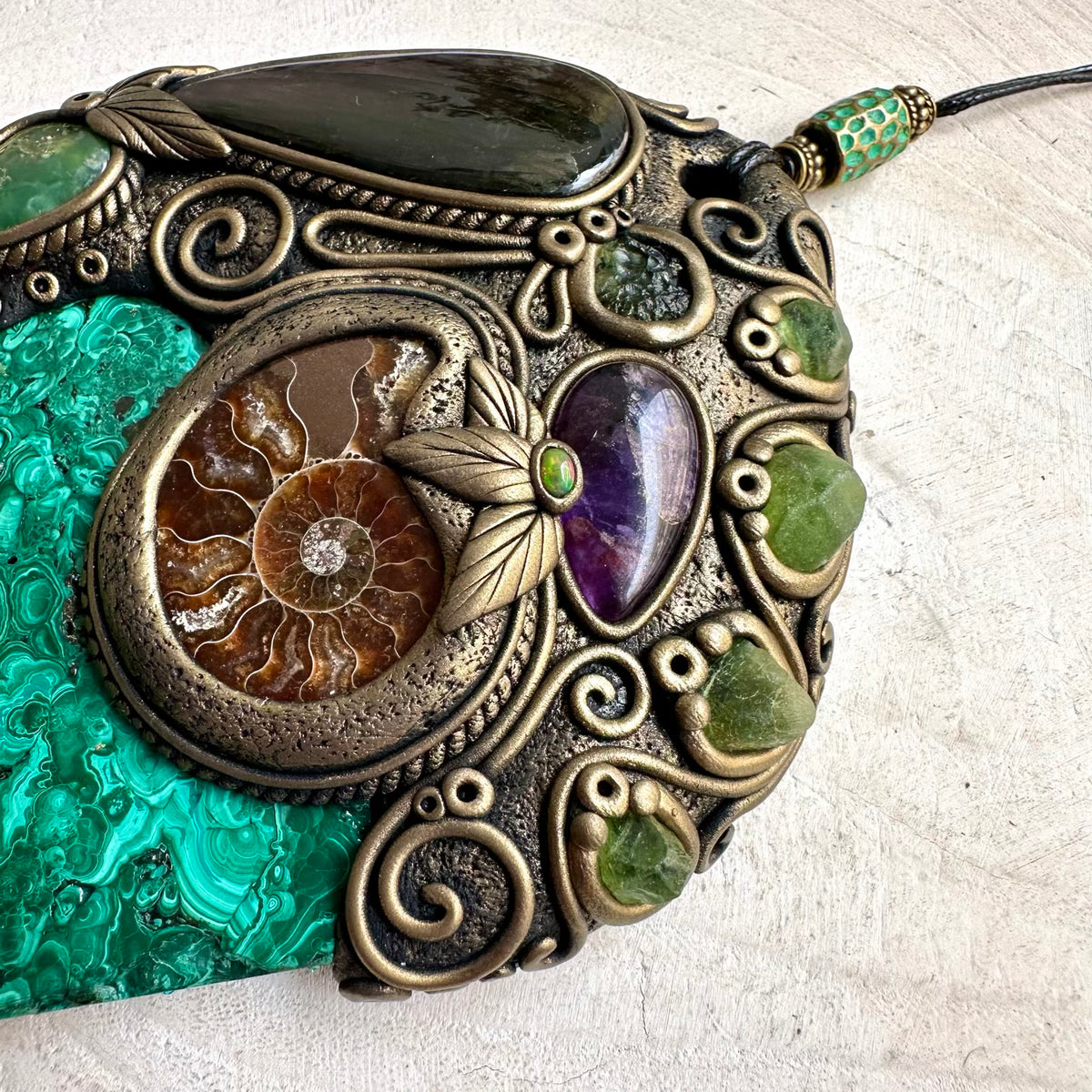 Handmade healing crystal wall hanging with Malachite and multiple natural gemstones, created for meditation spaces and spiritual interiors.