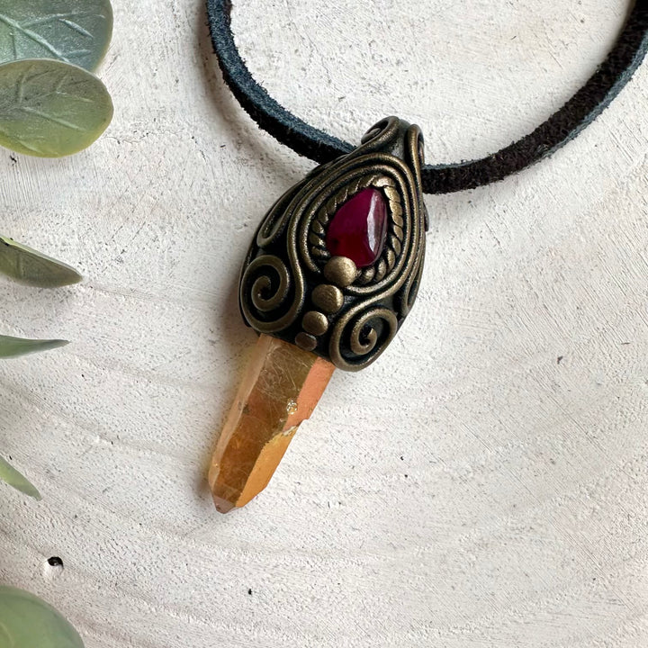 Protection amulet necklace featuring healing crystals Sunset Aura Quartz and Rhodolite Garnet gemstones.