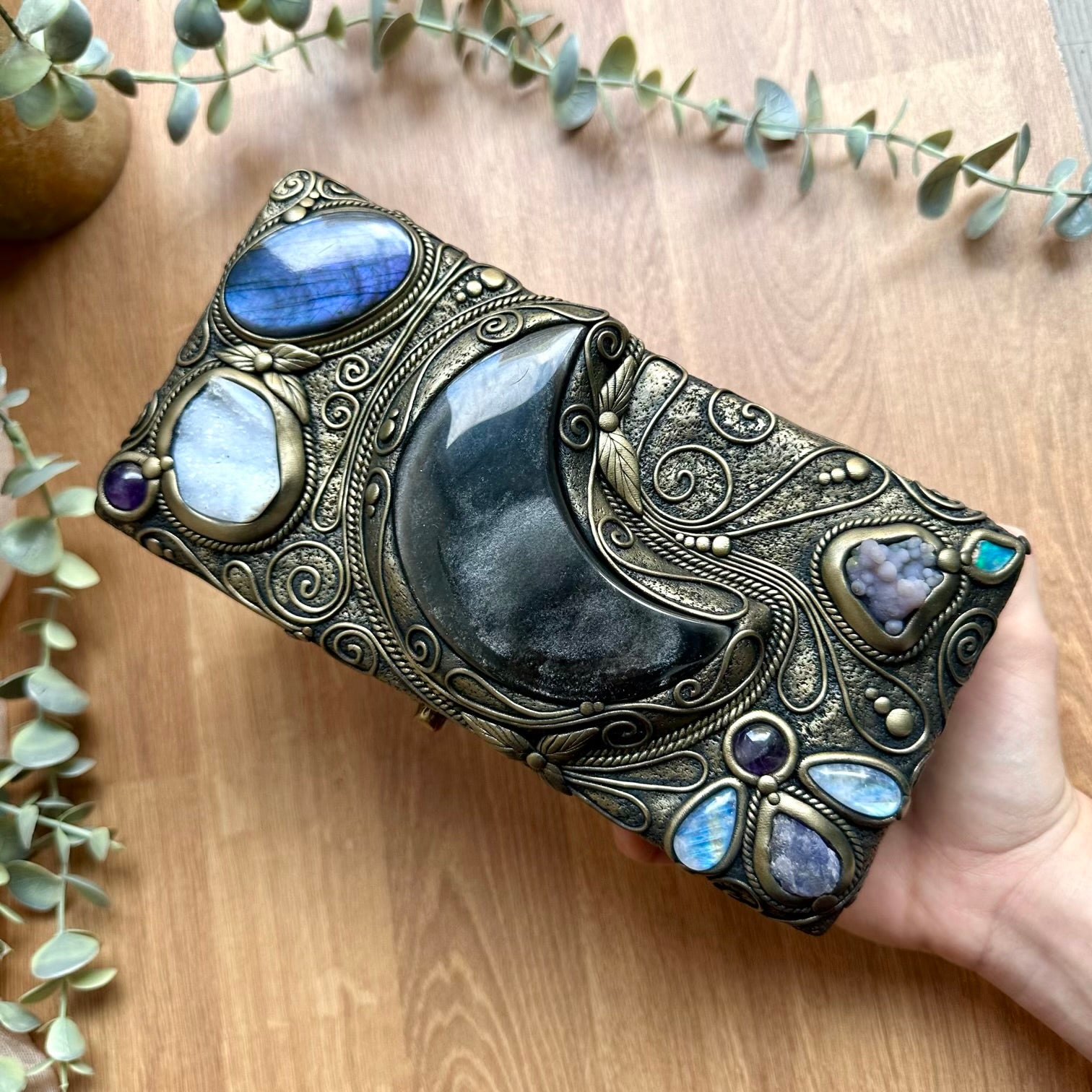 Handmade wooden box decorated with crystals, featuring a silver sheen obsidian moon centerpiece