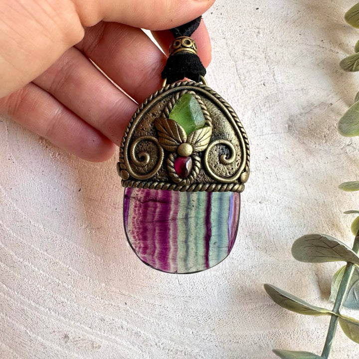 Handmade gemstone pendant combining Rainbow Fluorite with Raw Peridot and Rhodolite Garnet.