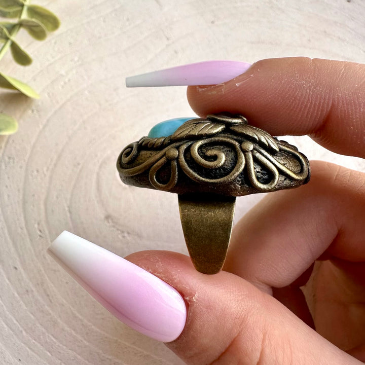 Handmade healing crystal ring featuring Larimar, Ethiopian Opal and Rhodolite Garnet gemstones.