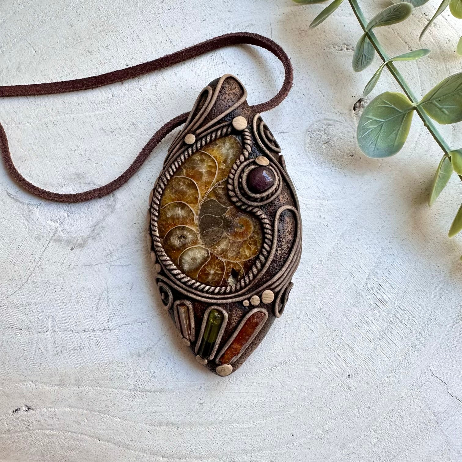 Handmade necklace with ammonite garnet kyanite tourmaline and topaz gemstones