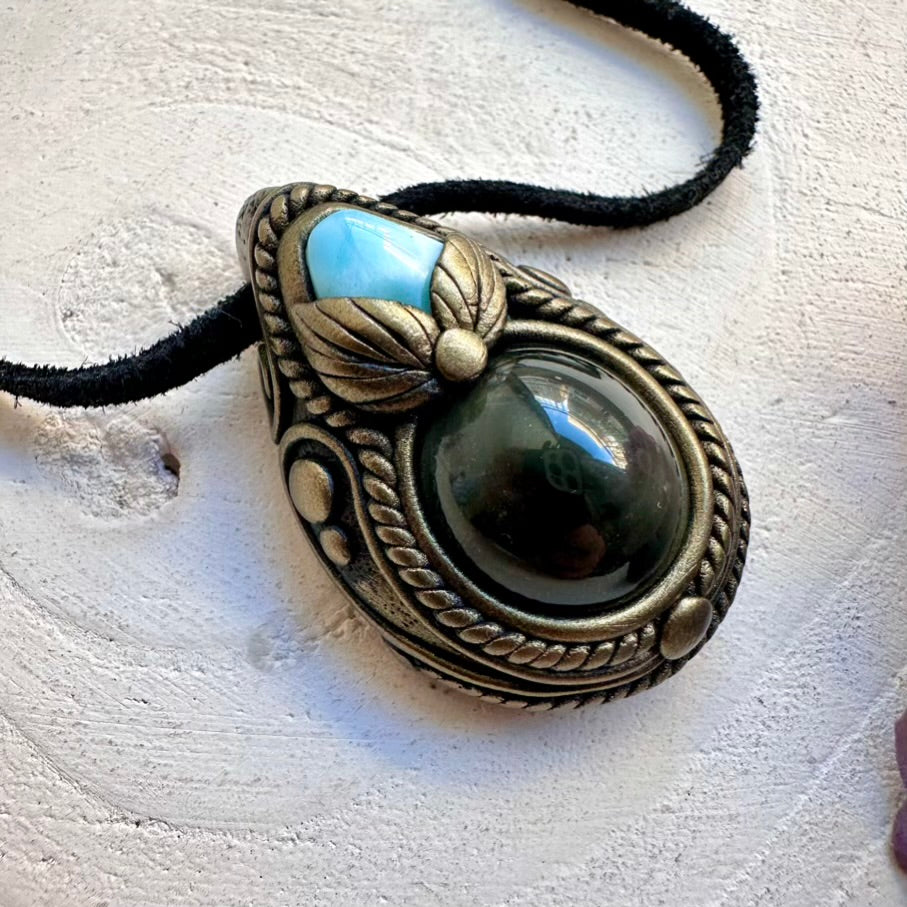 Handmade energy tool necklace with a protective eye-like rainbow sheen Obsidian pendant and ocean-calm Larimar crystal energy.