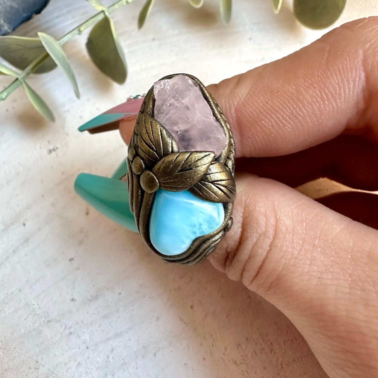 Larimar heart paired with raw rose quartz in a ring