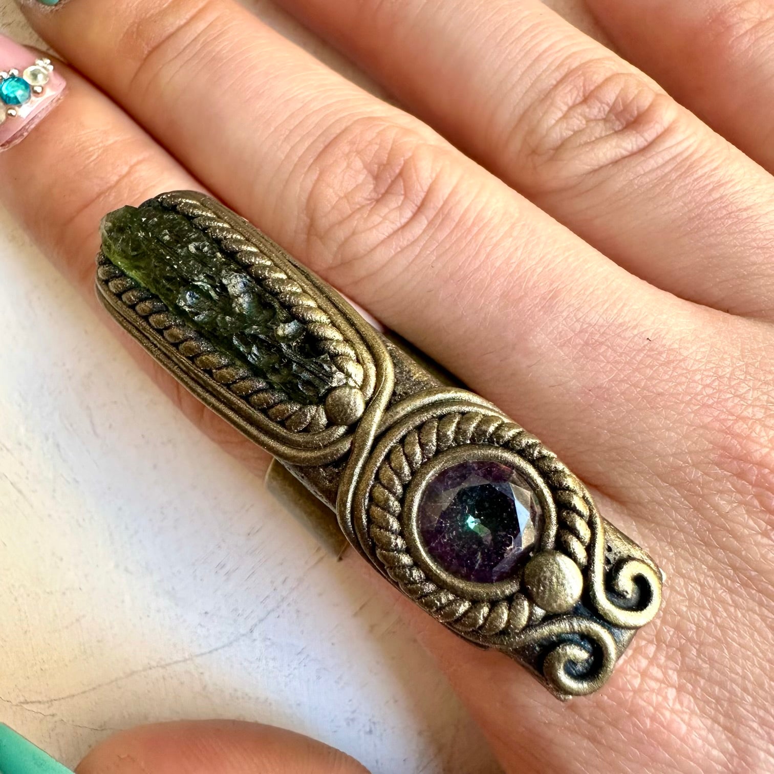 Moldavite paired with mystic topaz in a gemstone ring