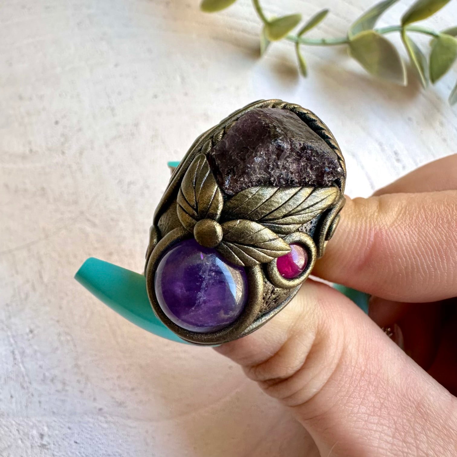 Scapolite paired with rhodolite garnet and amethyst in a ring
