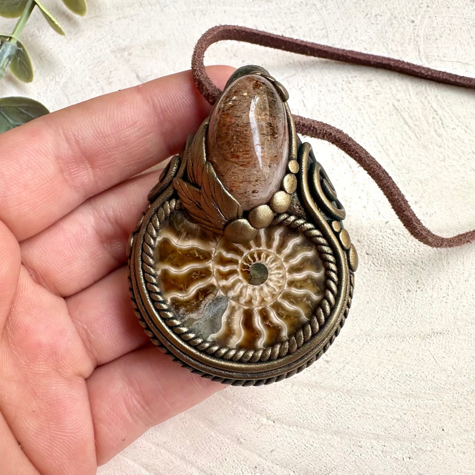 Hematite quartz crystal pendant necklace with ammonite fossil and metaphysical healing stone aesthetic