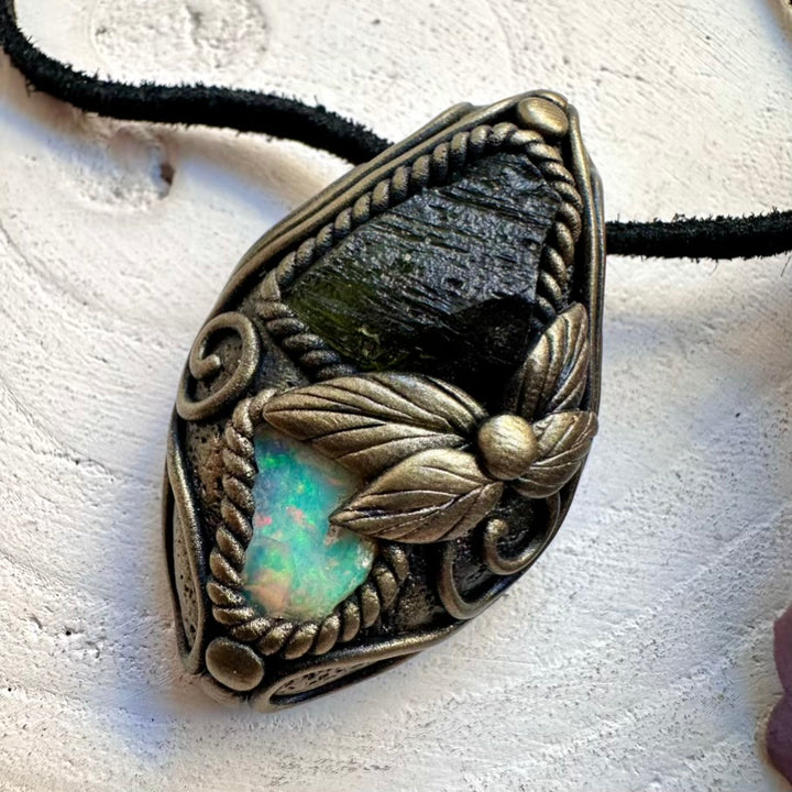 Handmade high-vibration healing crystal pendant necklace featuring rare raw Moldavite and raw Ethiopian Opal fire flash.