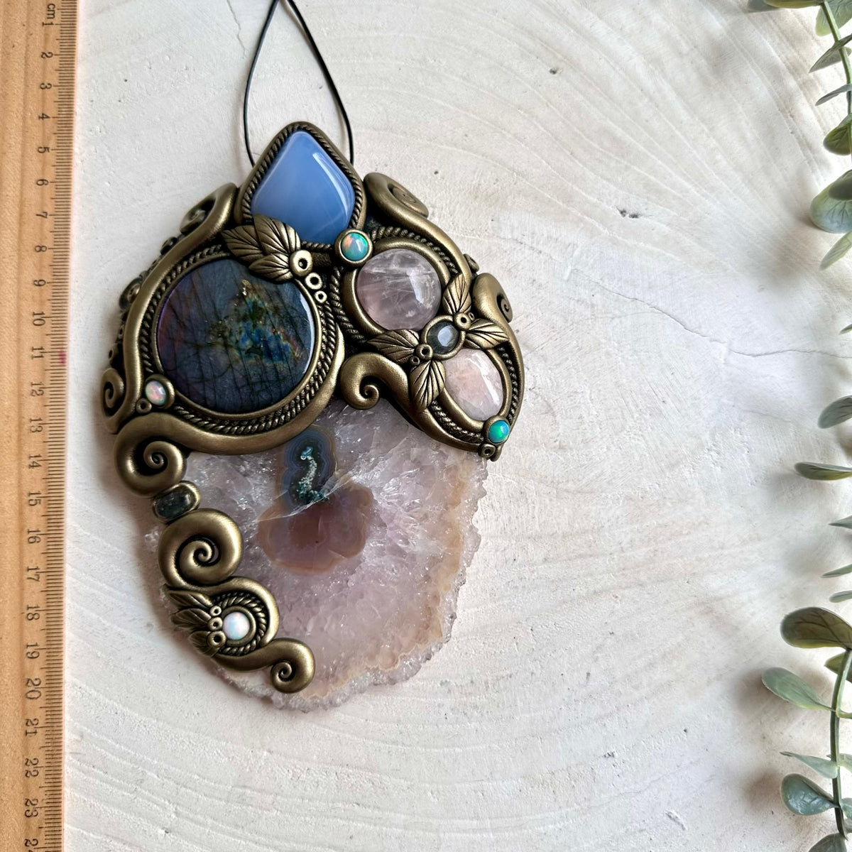 Handmade crystal wall hanging featuring a large Amethyst Stalactite with Purple Labradorite, Blue Chalcedony, Rose Quartz, Morganite, Ethiopian Opal and Clear Topaz.