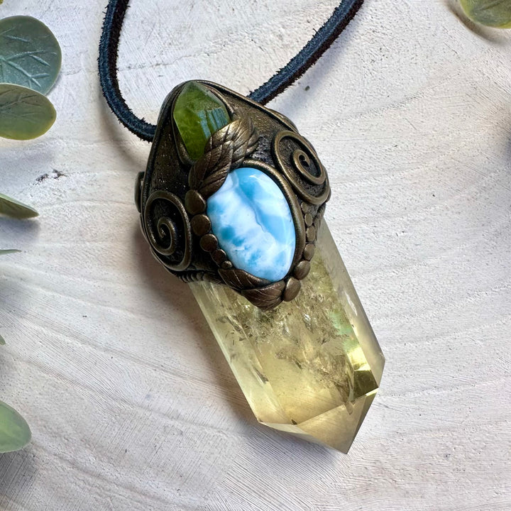 Citrine paired with raw peridot and larimar in a wand pendant