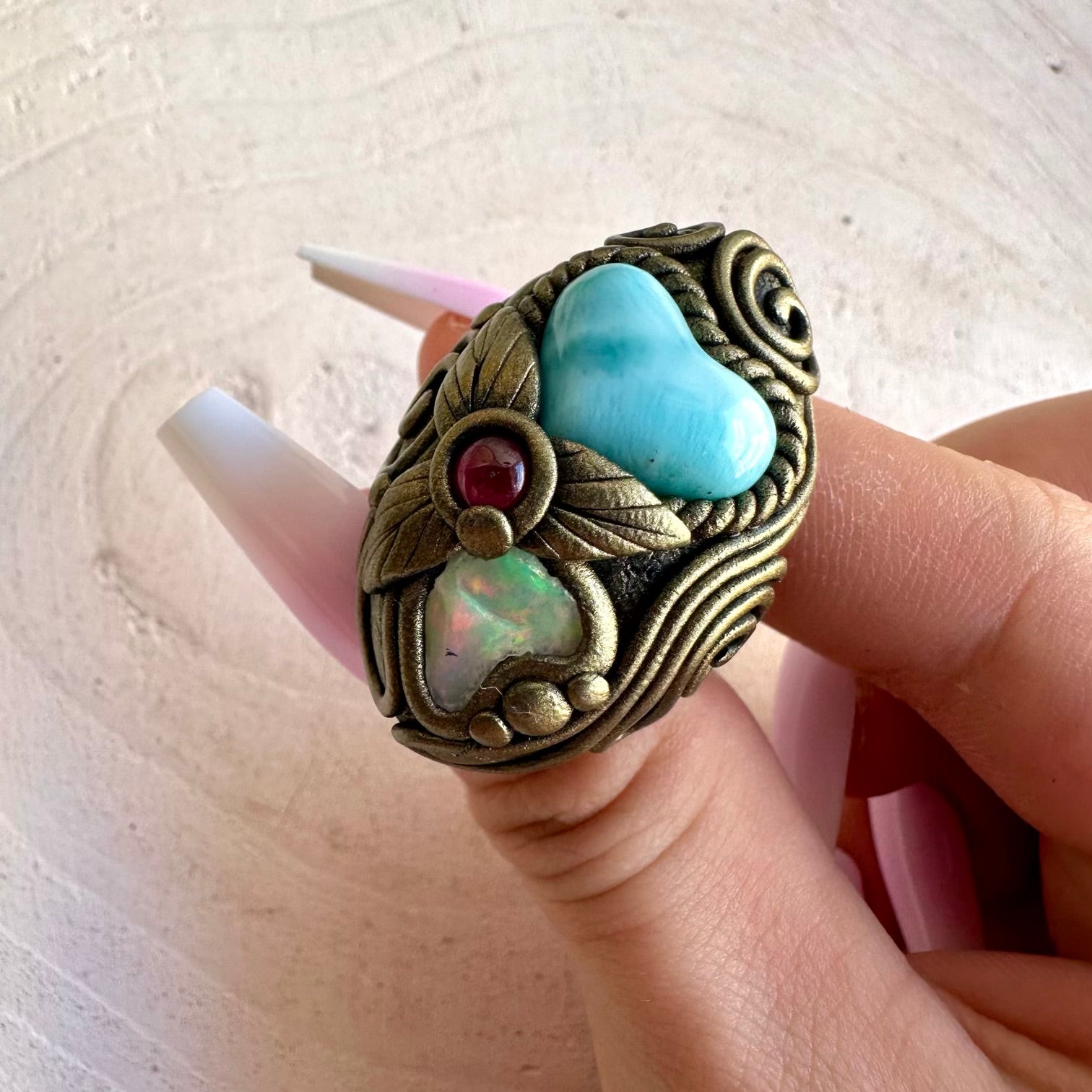Handmade crystal jewelry combining Larimar, Raw Ethiopian Opal and Rhodolite Garnet in boho clay setting.