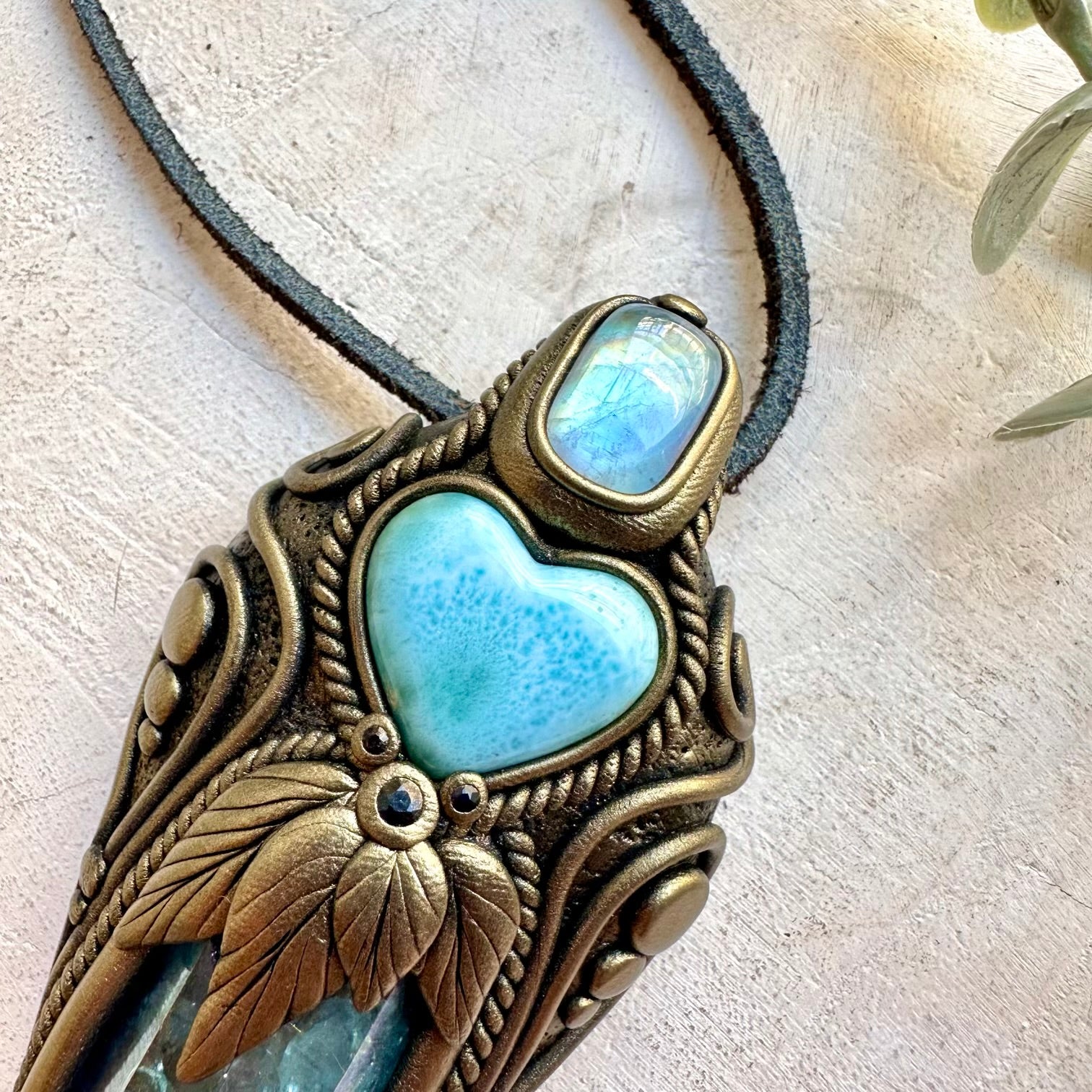Crystal wand pendant featuring ocean-blue Larimar Heart and luminous Aqua Aura Quartz.