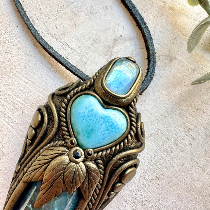 Crystal wand pendant featuring ocean-blue Larimar Heart and luminous Aqua Aura Quartz.