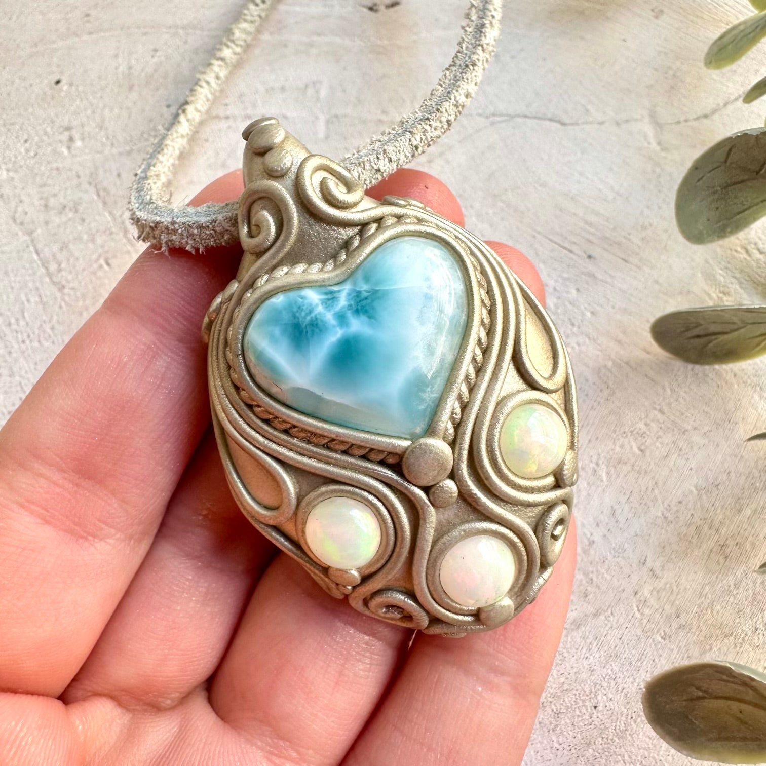 Handmade Larimar Heart and Ethiopian Opal pendant necklace, a one of a kind gemstone jewelry piece combining soothing ocean-blue Larimar with the natural flashes of colorful Ethiopian Opal. An enchanting spiritual necklace inspired by tranquility, creativity, emotional balance, intuition and personal transformation.