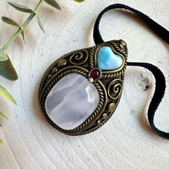 Handmade gemstone necklace with Mango Calcite, Larimar and Rhodolite Garnet in an artistic setting.