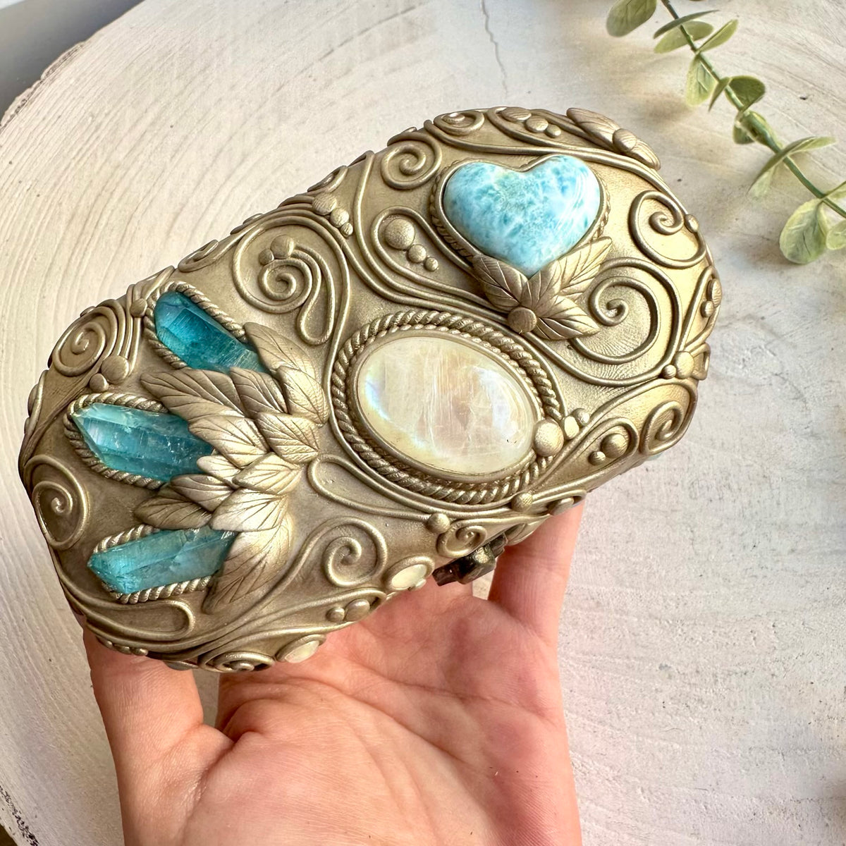 Handmade healing crystal home decor box with Aqua Aura Quartz and colorful gemstone accents.
