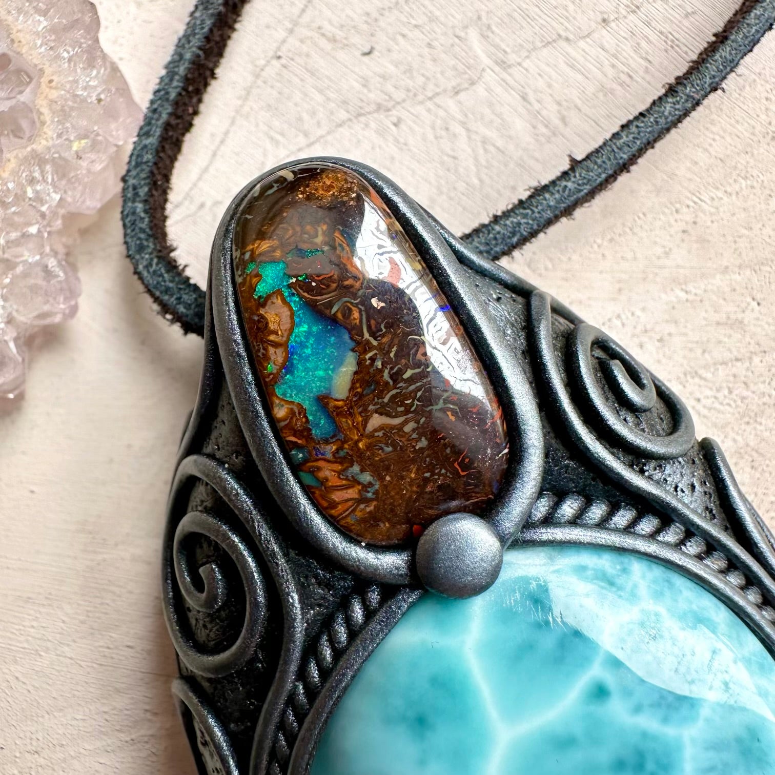 Close up of larimar and boulder opal pendant
