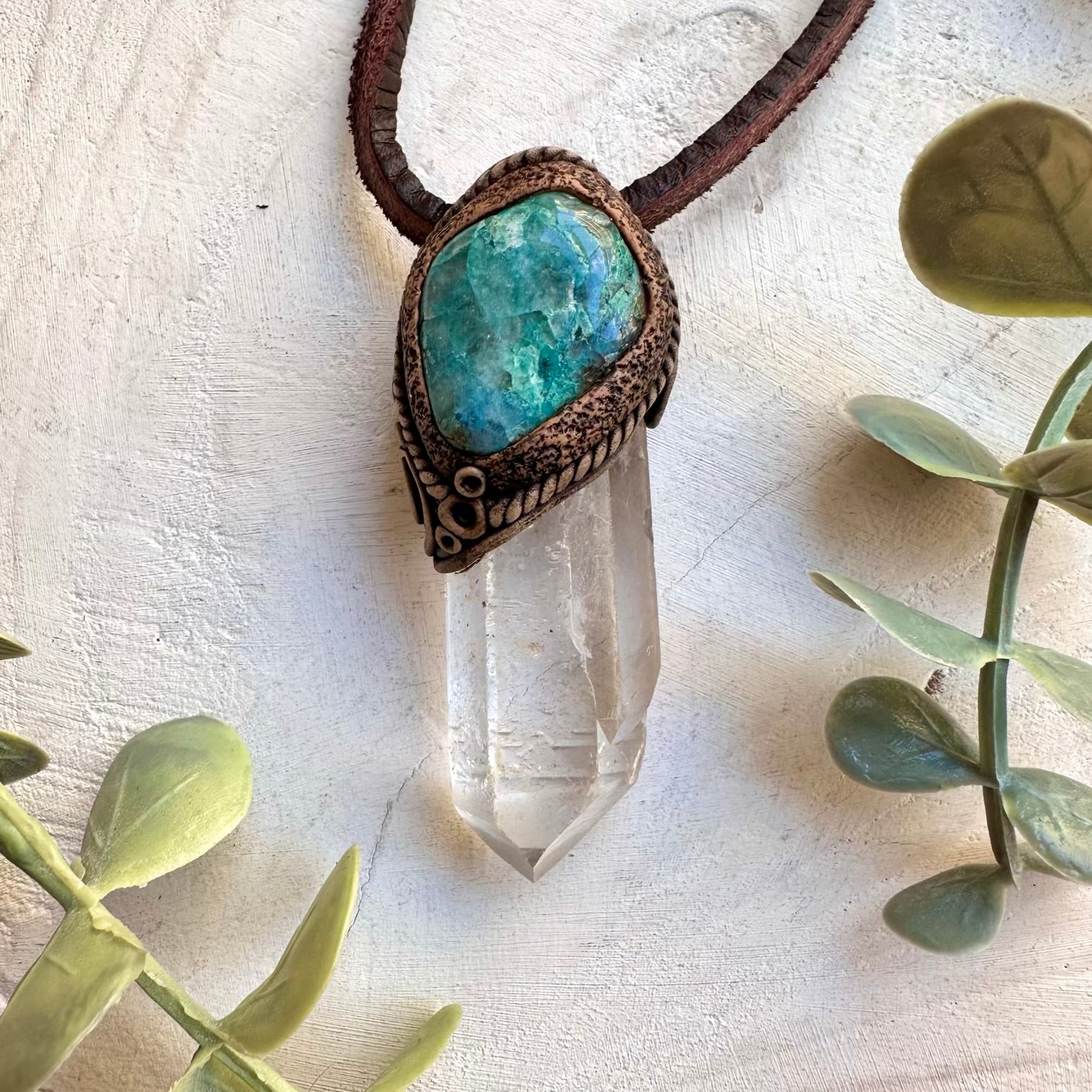 Clear quartz point paired with chrysocolla in a necklace