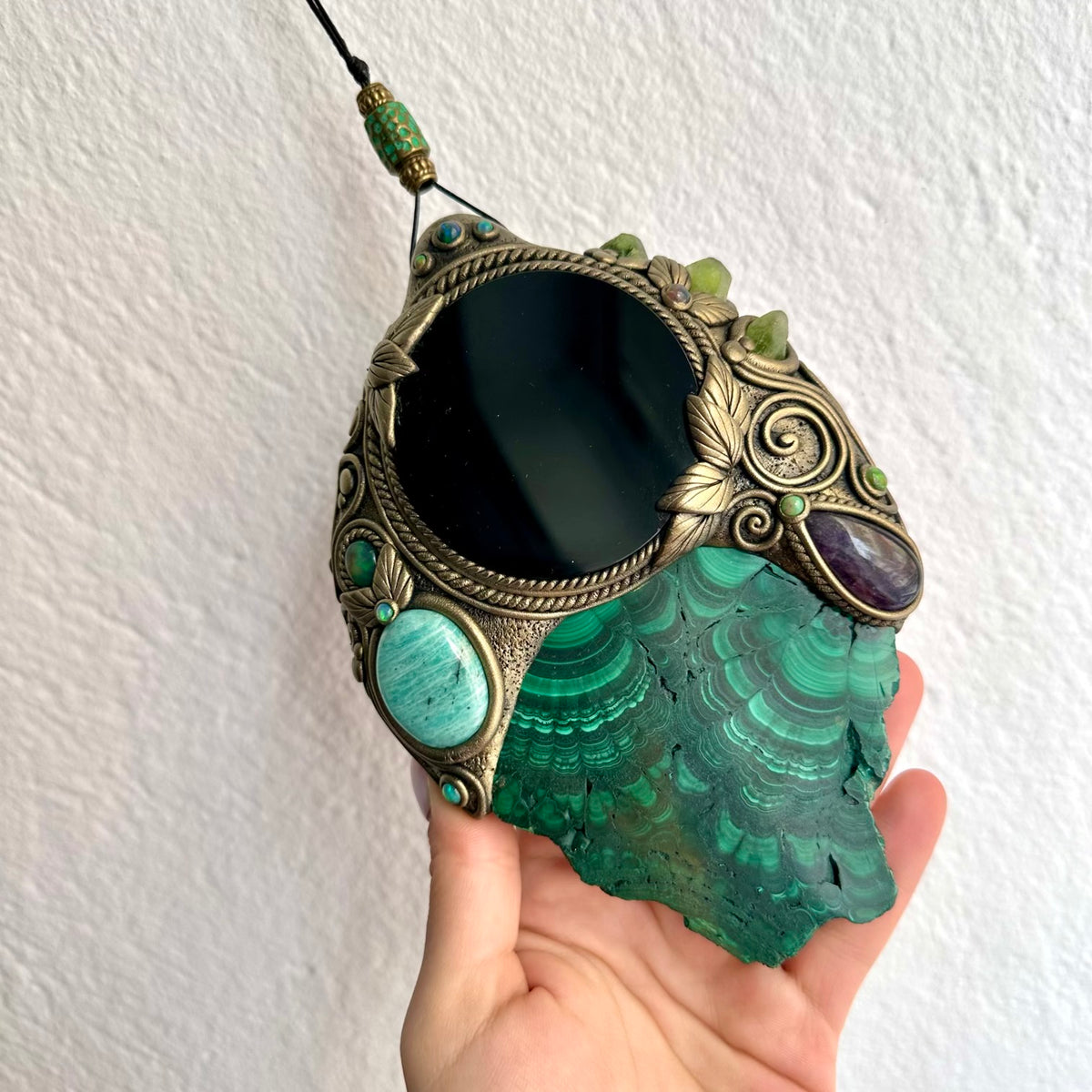  this handmade crystal mirror is a meaningful piece of spiritual art for anyone drawn to natural gemstones, healing crystal decor, scrying-inspired interiors and unique artisan home decoration.