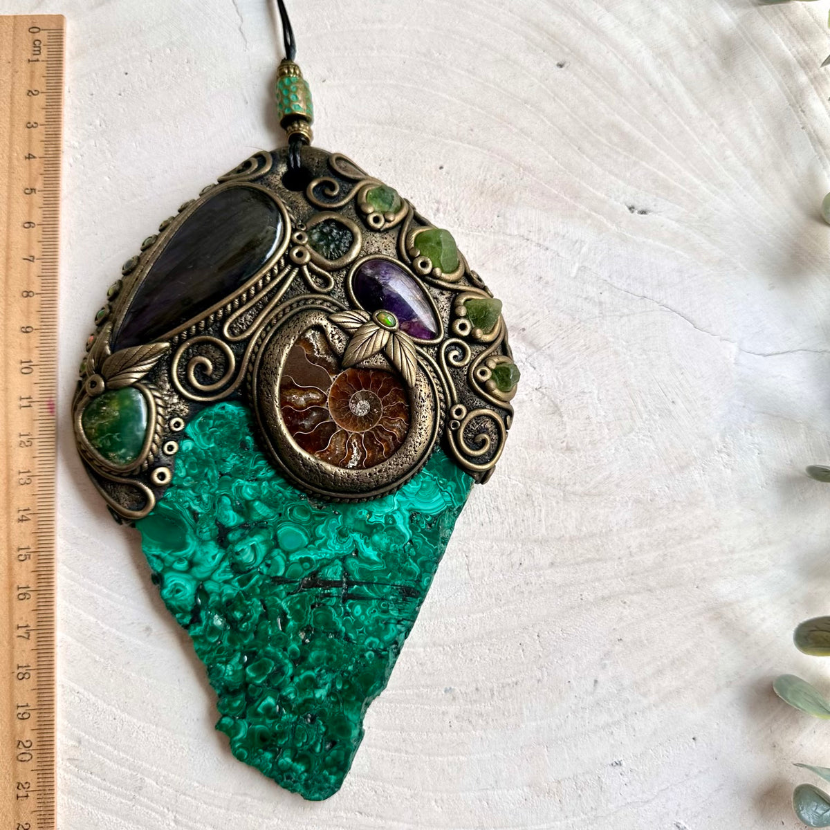 Handmade crystal wall art featuring vivid Malachite with natural gemstones and an ancient Ammonite fossil.