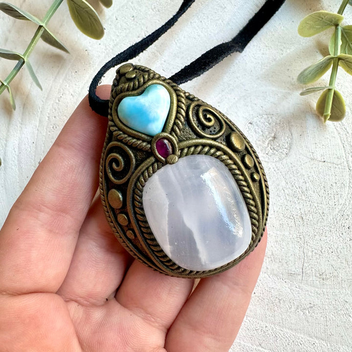 Handmade Mango Calcite necklace featuring a Larimar Heart and Rhodolite Garnet, a one of a kind gemstone jewelry piece combining warm golden tones, ocean-blue Larimar and deep red Garnet. Artisan crystal jewelry crafted with genuine natural stones for a unique, meaningful and beautiful statement piece.