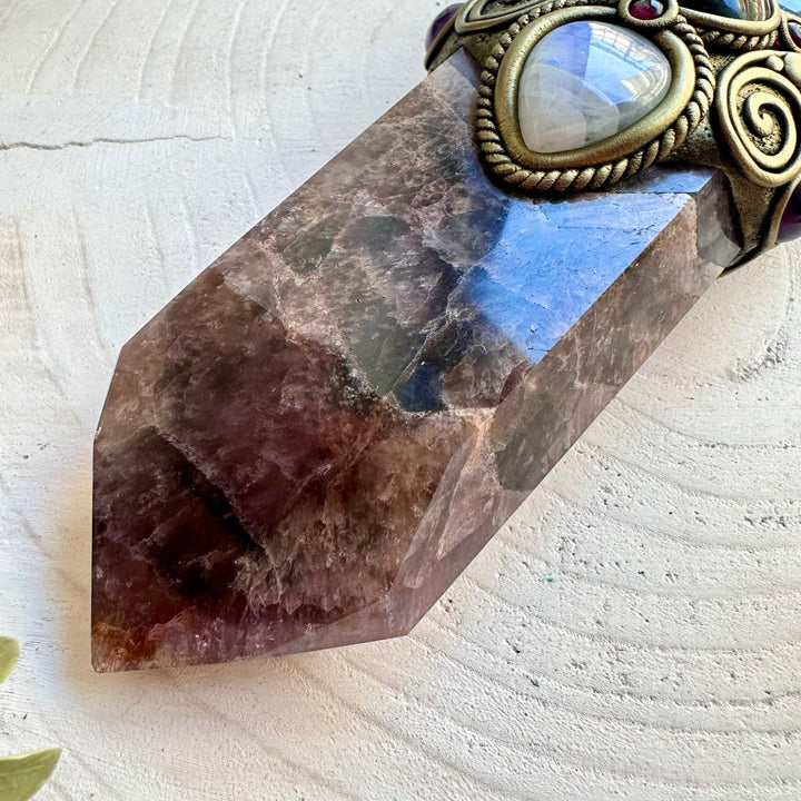 Beautiful healing crystal wand featuring Super Seven Quartz and an Astrophyllite moon in a handmade clay design.