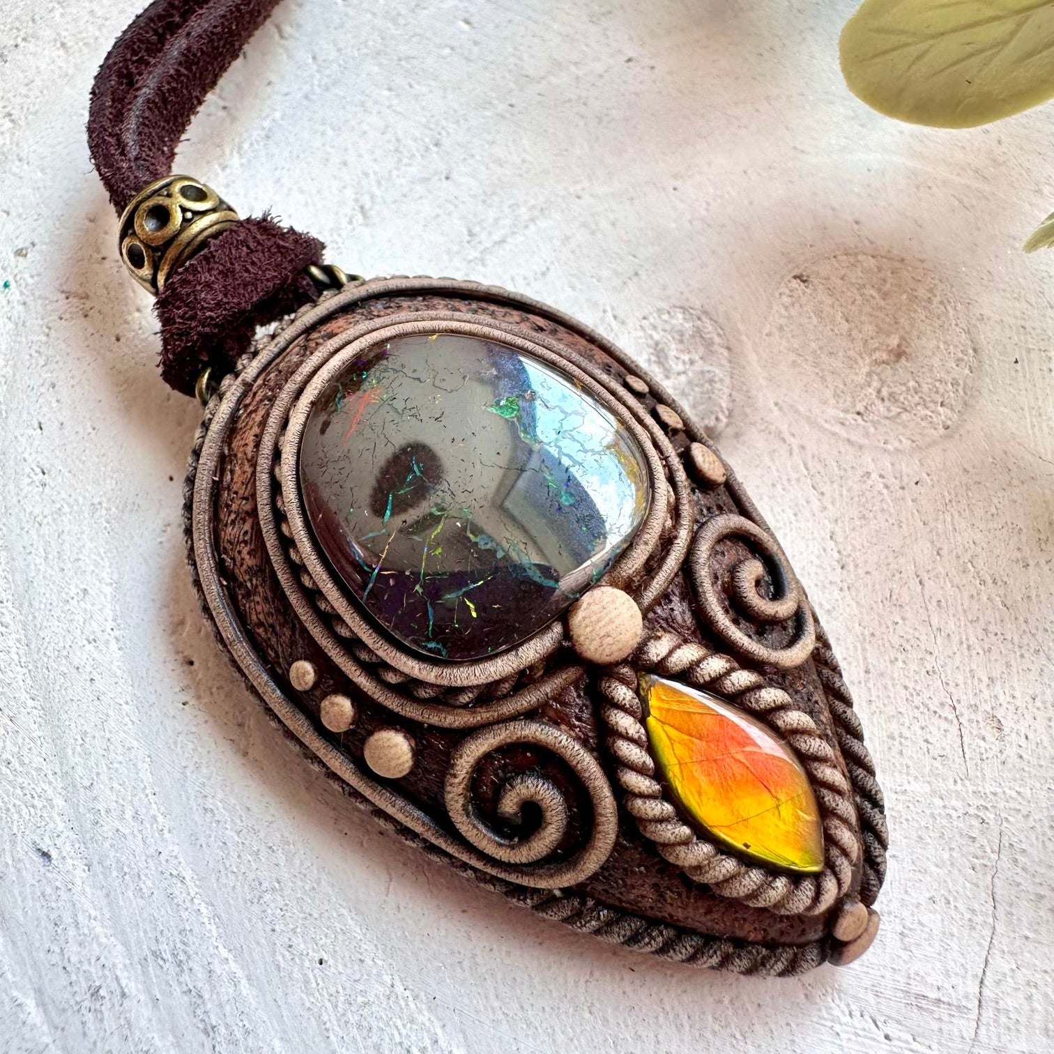 One of a kind crystal pendant handcrafted with natural Boulder Opal and Ammolite.