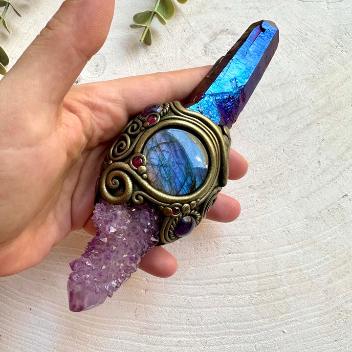 Handmade raw crystal wand featuring Cobalt Aura Quartz, Deep Purple Spirit Quartz, Labradorite, Amethyst and Rhodolite Garnet, a one of a kind energy healing and ritual tool designed for spiritual awakening, intuition, communication, protection and personal transformation.