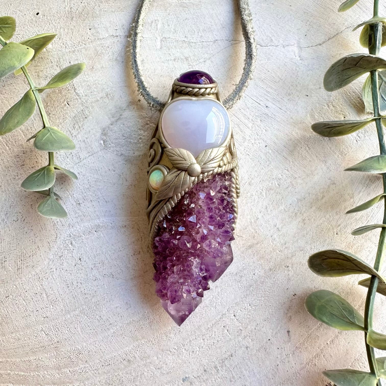 Unique crystal wand pendant featuring a Blue Chalcedony Heart with shimmering Spirit Quartz crystals.