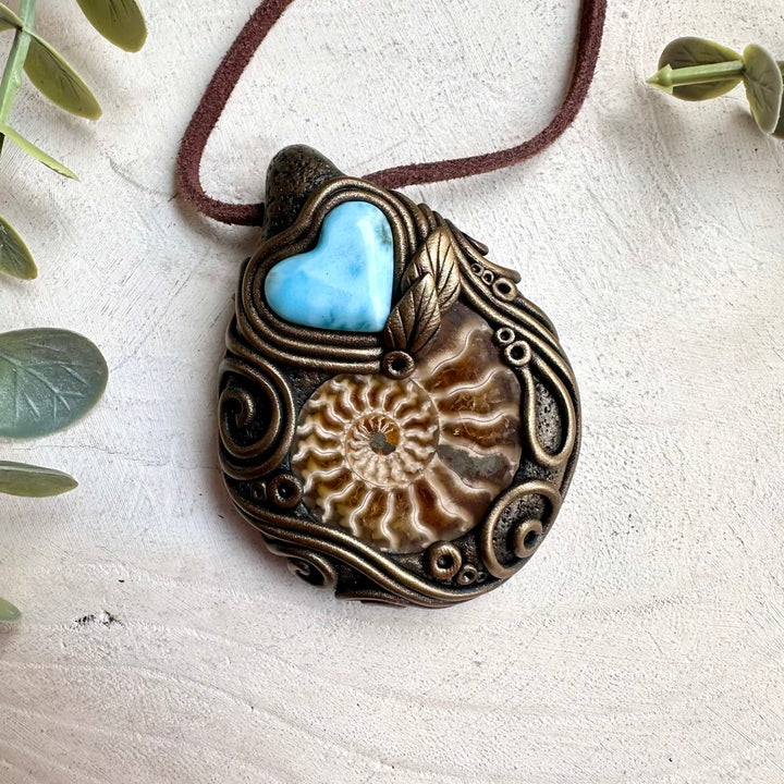Mineral specimen inspired necklace with larimar heart crystal and ammonite fossil pendant